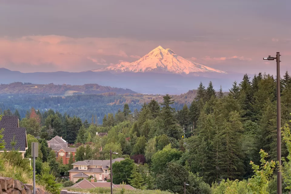 View of Mount Hood at golden hour with Happy Valley, Oregon homes in foreground.